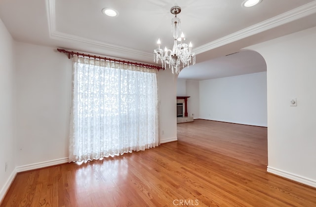 814 S Patton Ave Unit 2, San Pedro, CA 90731 - unfurnished room with a chandelier, arched walkways, wood finished floors, crown molding, and baseboards