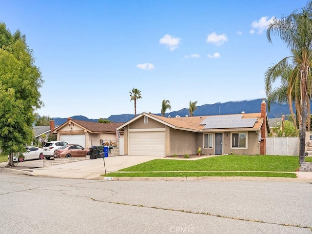 10478 Nutmeg St, Rancho Cucamonga, CA 91730 - ranch-style home with driveway, solar panels, a garage, fence, and a front lawn