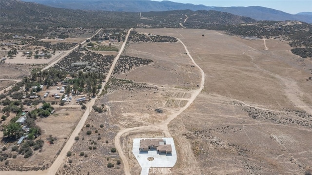 drone / aerial view featuring a rural view, a mountain view, and view of desert