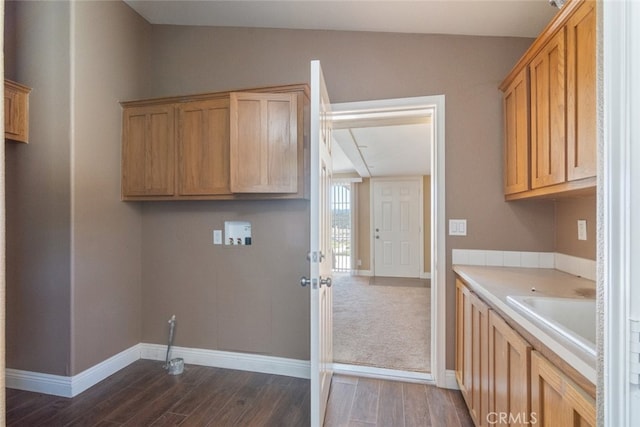 laundry area featuring baseboards, dark wood-style flooring, cabinet space, and washer hookup