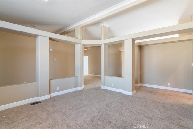 below grade area featuring visible vents, carpet flooring, and baseboards