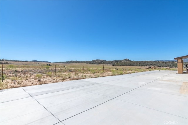 view of patio featuring a mountain view and a rural view