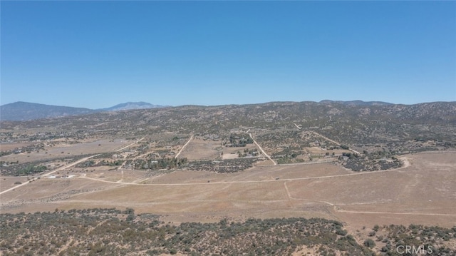 property view of mountains featuring view of desert and a rural view