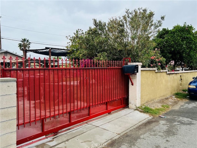 view of gate with a fenced front yard