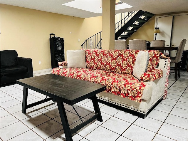 living room featuring stairs and light tile patterned flooring