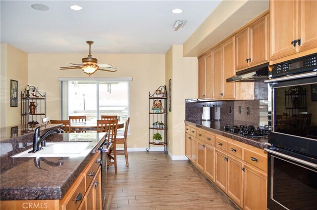 38256 Wild Poppy Ln, Yucaipa, CA 92399 - kitchen with black appliances, under cabinet range hood, a sink, a ceiling fan, and decorative backsplash