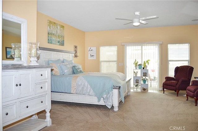 bedroom with access to outside and light carpet