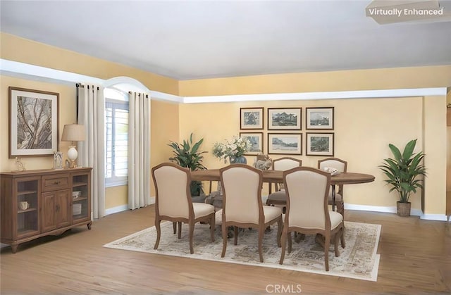 dining area featuring baseboards and wood finished floors