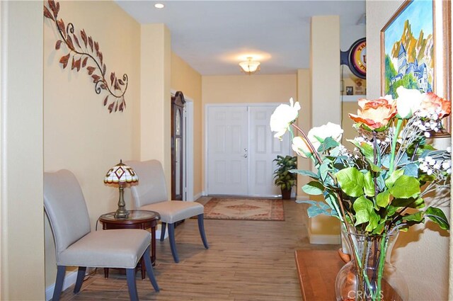 interior space with baseboards, recessed lighting, and wood finished floors