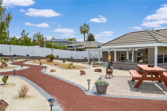 view of community with a fenced backyard and a patio