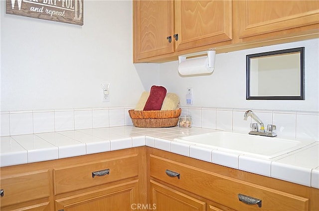 kitchen featuring light countertops and a sink