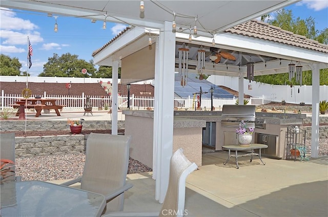 view of patio / terrace with a gazebo, fence, and area for grilling