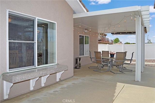view of patio / terrace featuring fence and outdoor dining space