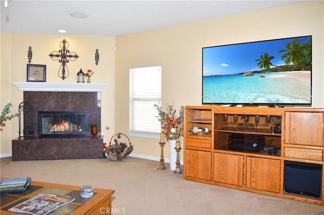 carpeted living area with baseboards and a fireplace