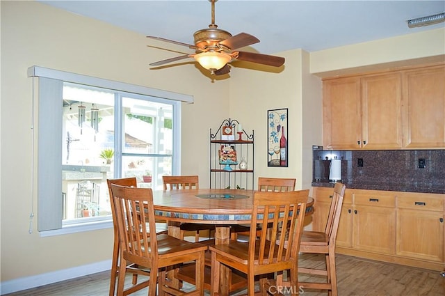 dining area with baseboards, ceiling fan, light wood-style flooring, and visible vents