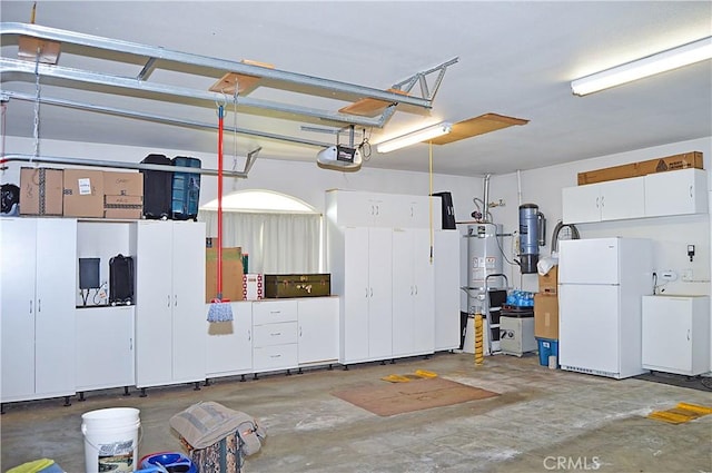garage with freestanding refrigerator, strapped water heater, and a garage door opener