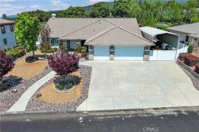 38256 Wild Poppy Ln, Yucaipa, CA 92399 - single story home featuring an attached garage, a tile roof, driveway, and stucco siding