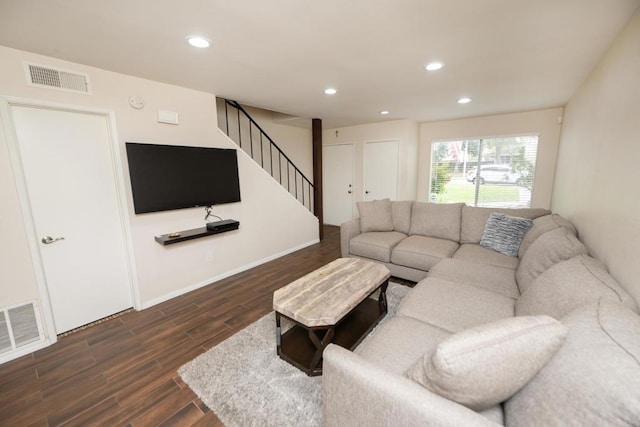 living room featuring stairway, dark wood-type flooring, recessed lighting, and visible vents