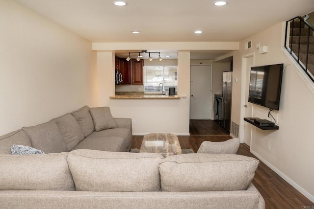 living room with baseboards, recessed lighting, and dark wood-type flooring