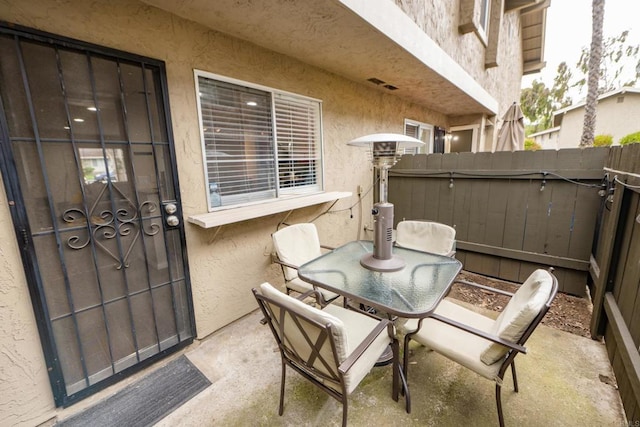 view of patio with fence and outdoor dining area