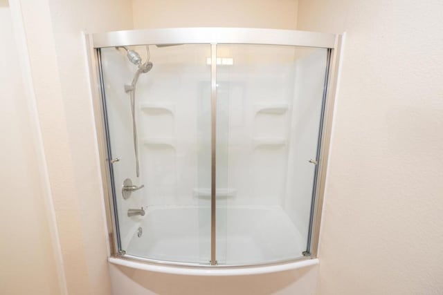 full bathroom featuring shower / bath combination with glass door