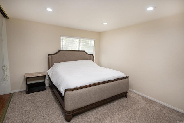 bedroom featuring recessed lighting, baseboards, and light carpet
