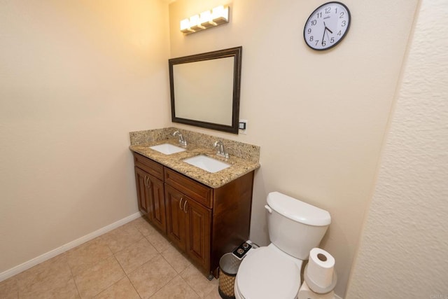 bathroom featuring tile patterned flooring, a sink, baseboards, and toilet