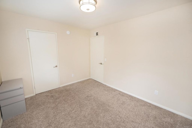 empty room with carpet flooring and baseboards