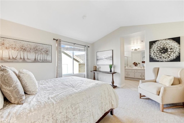 bedroom featuring baseboards, tile patterned flooring, vaulted ceiling, and connected bathroom