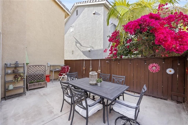view of patio with fence and outdoor dining area