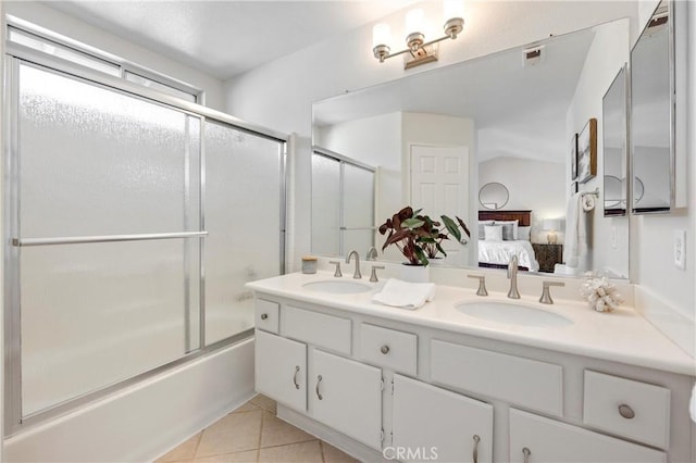ensuite bathroom with a sink, tile patterned floors, double vanity, and connected bathroom