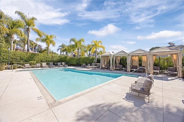 pool with a gazebo and a patio area