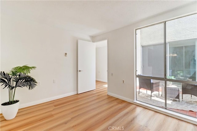 125 Via Estrada Unit B, Laguna Woods, CA 92637 - unfurnished room with wood finished floors and baseboards