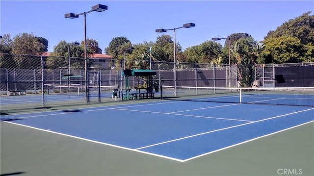 125 Via Estrada Unit B, Laguna Woods, CA 92637 - view of tennis court featuring fence and community basketball court
