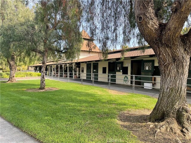 125 Via Estrada Unit B, Laguna Woods, CA 92637 - back of house featuring an exterior structure and a shingled roof