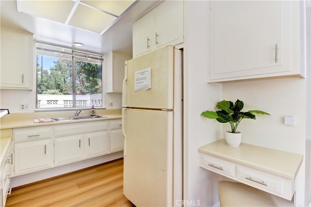 125 Via Estrada Unit B, Laguna Woods, CA 92637 - kitchen with freestanding refrigerator, a sink, white cabinets, and light countertops
