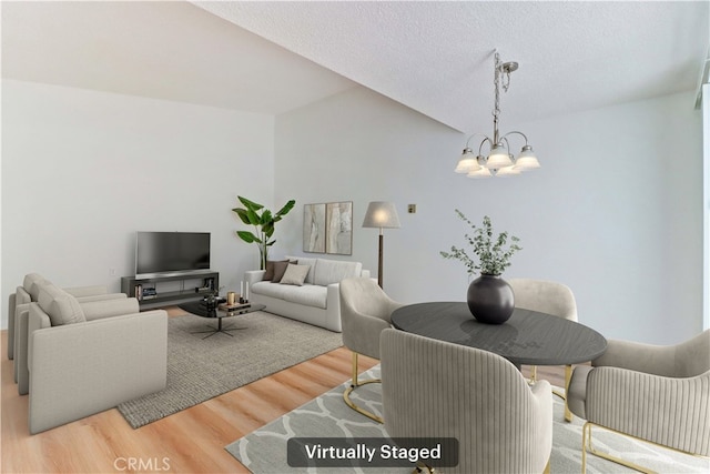 125 Via Estrada Unit B, Laguna Woods, CA 92637 - living area featuring a textured ceiling, a notable chandelier, and wood finished floors