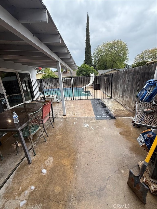 view of patio / terrace with a fenced in pool and fence