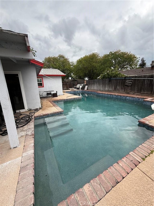 view of swimming pool with a fenced in pool and a fenced backyard