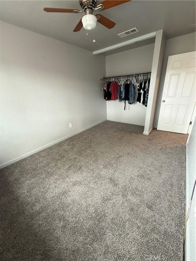 unfurnished bedroom with visible vents, carpet flooring, baseboards, and ceiling fan