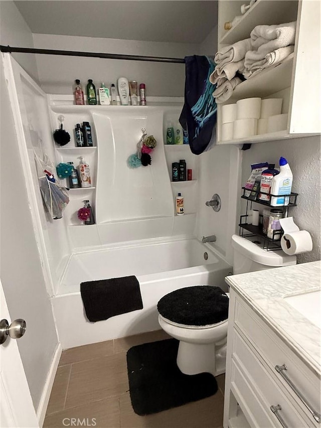 full bath featuring vanity, tile patterned floors, shower / bath combo with shower curtain, and toilet
