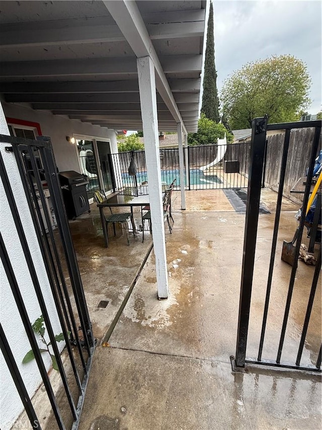 view of patio / terrace featuring fence and a fenced in pool
