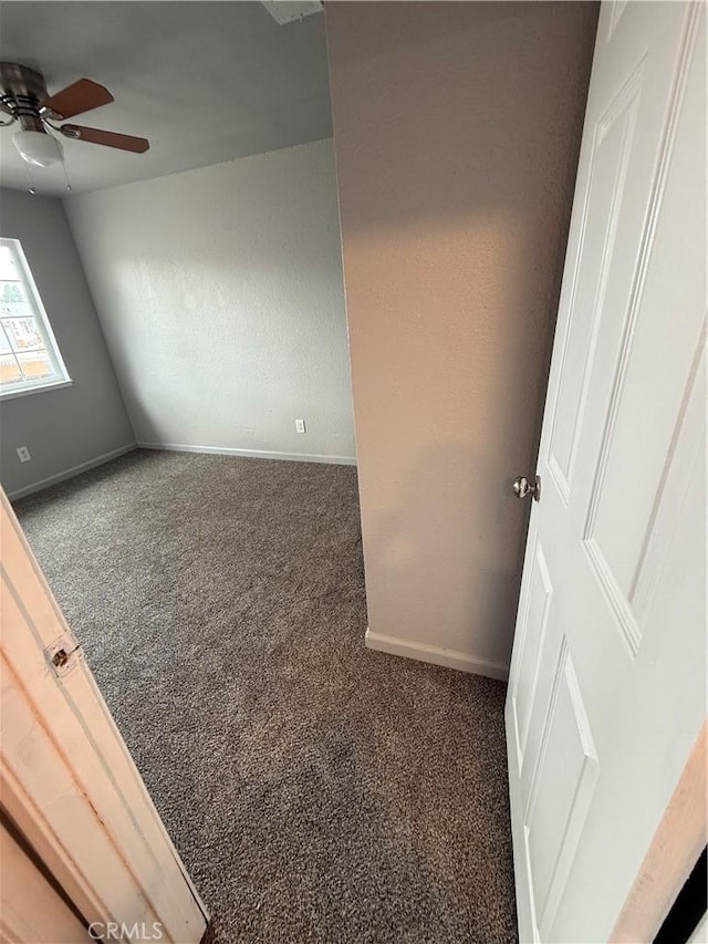 empty room with carpet flooring, baseboards, and ceiling fan
