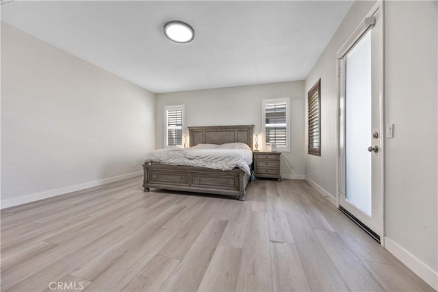 bedroom featuring baseboards and light wood-style flooring