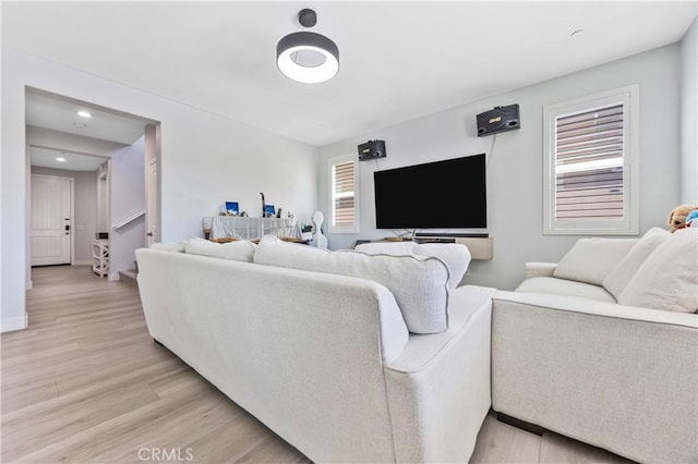 living area with recessed lighting and light wood-style flooring
