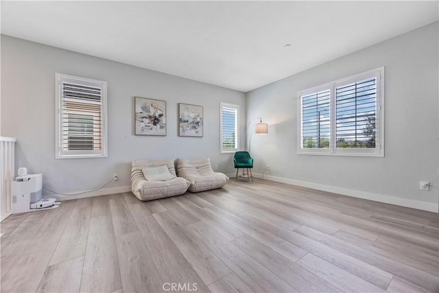 unfurnished room with baseboards and wood finished floors