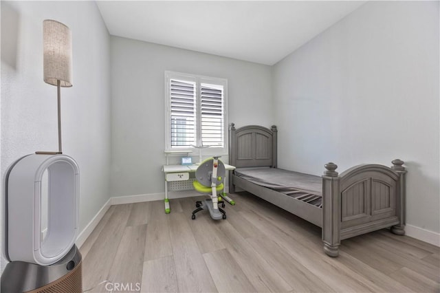 bedroom with baseboards and light wood-style flooring
