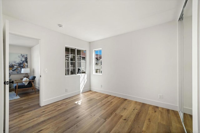 742 Eastshore Unit 98, Chula Vista, CA 91913 - unfurnished room featuring baseboards, light wood-style flooring, and a smoke detector