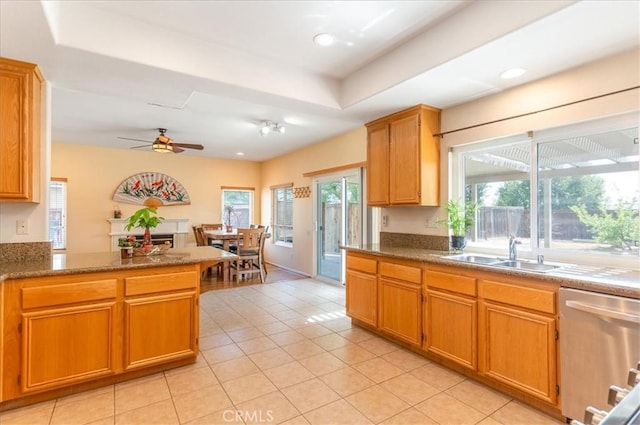 kitchen featuring ceiling fan, dishwasher, a sink, light tile patterned floors, and recessed lighting
