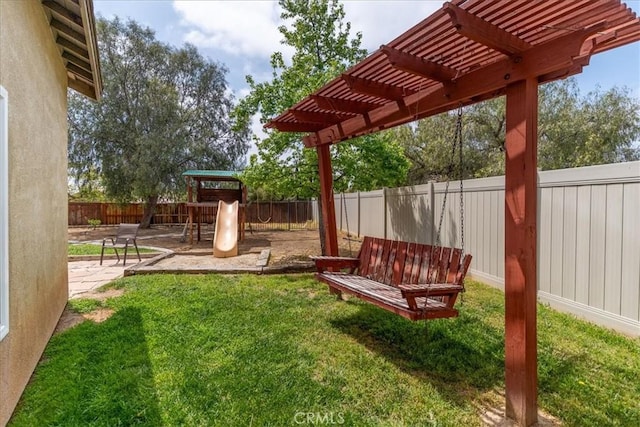 view of yard featuring a fenced backyard, a playground, and a pergola